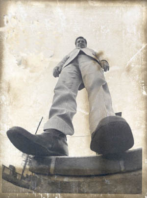 Distorted, fish-eyed view looking up at a man standing on a step.