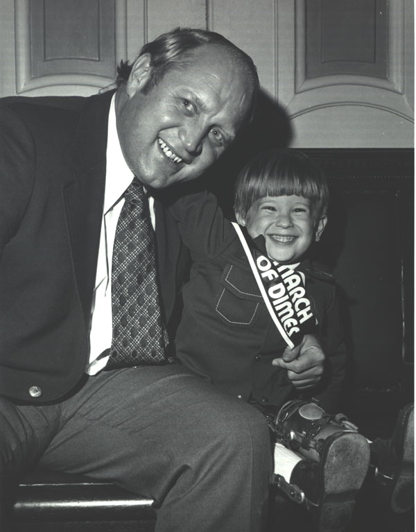Culver with March of Dimes poster child, Robbie Zastavny, 1977