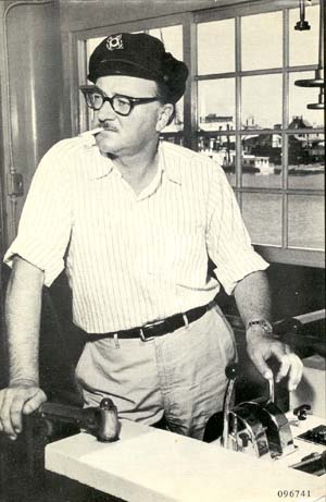 Richard Pike Bissel at the helm of a ship wearing a captain's hat.