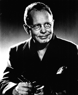 Grant Wood, holding paint brushes, not dated