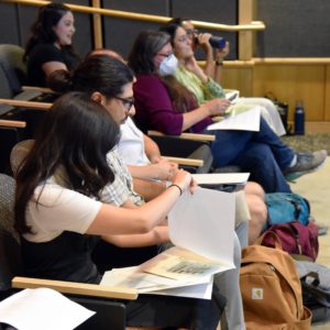 Summer fellows from the 2024 cohort watch as others present
