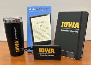 Photo of kindle, travel mug, power pack, and journal