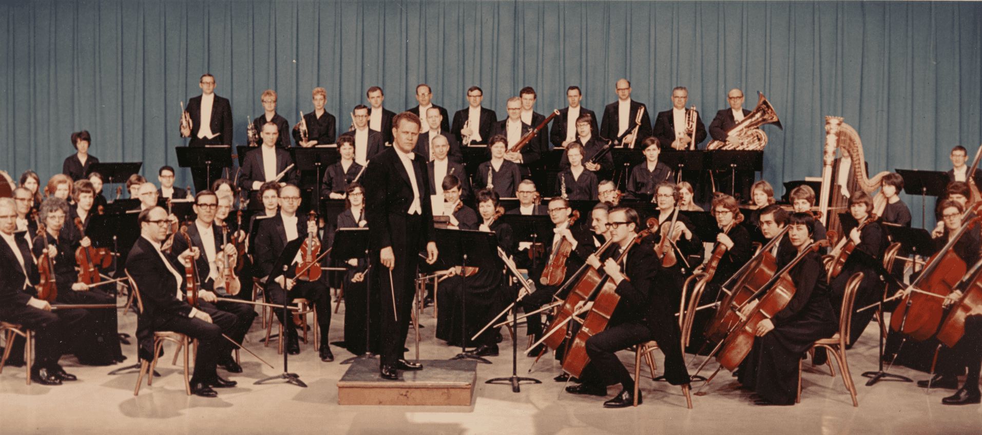 Conductor James Dixon stands in front of the Quad City Sympony orchestra as they pose for a photograph in 1968.