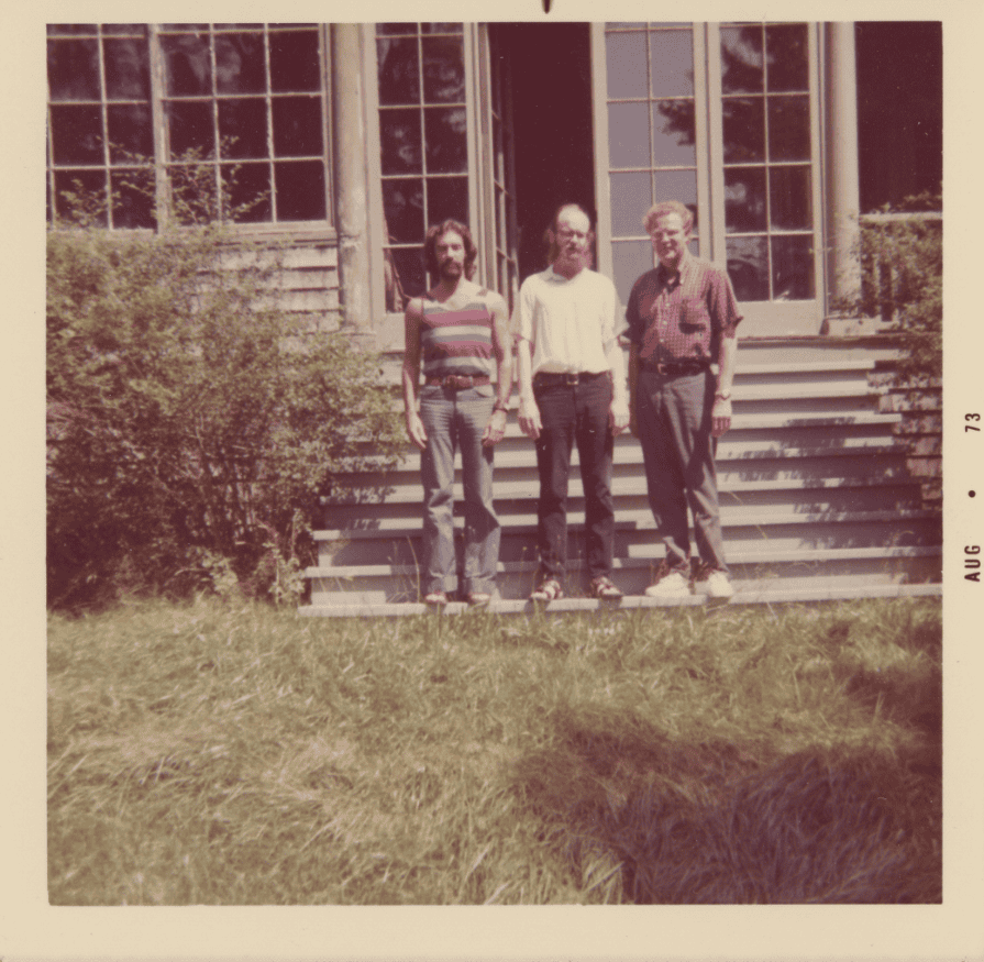 Dixon with friends Hibbard and Wuorinen. In this color photograph, the three men stand near the steps of a home in 1973.