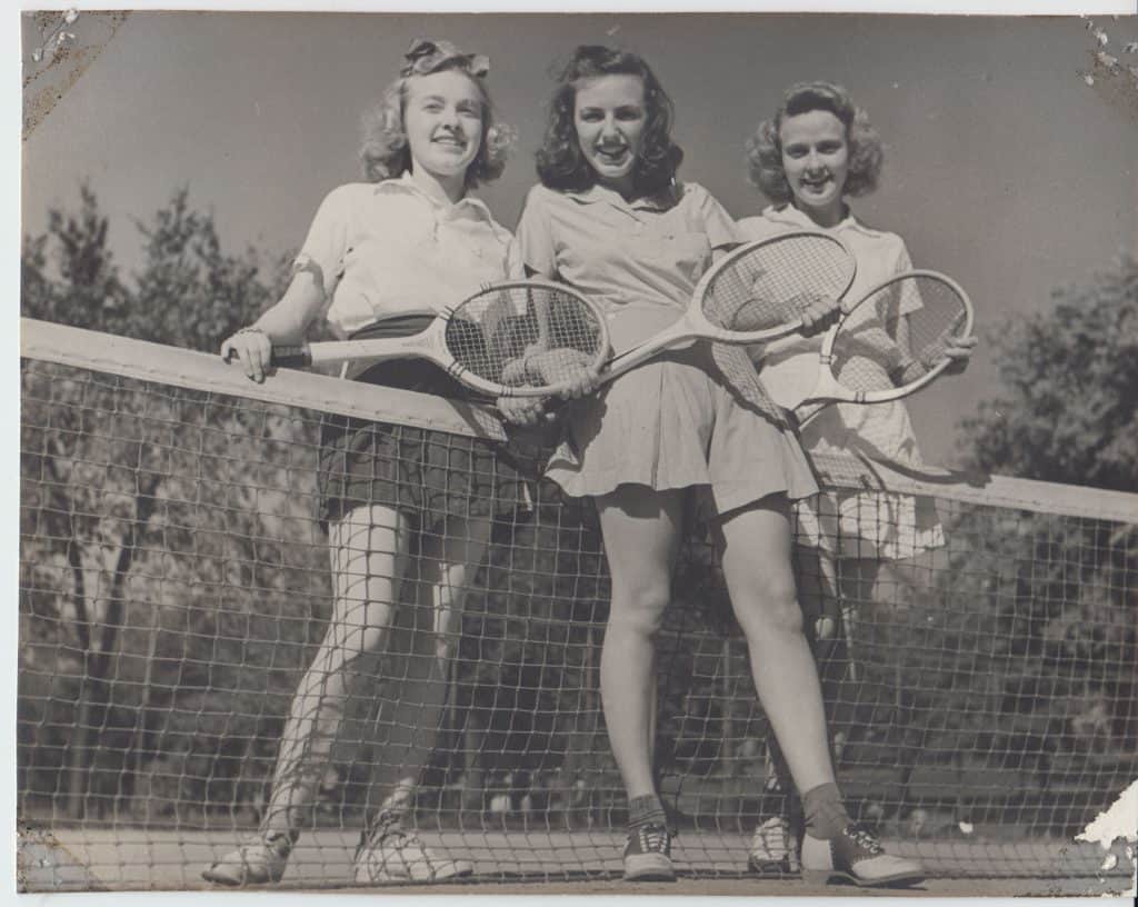 Three women playing tennis